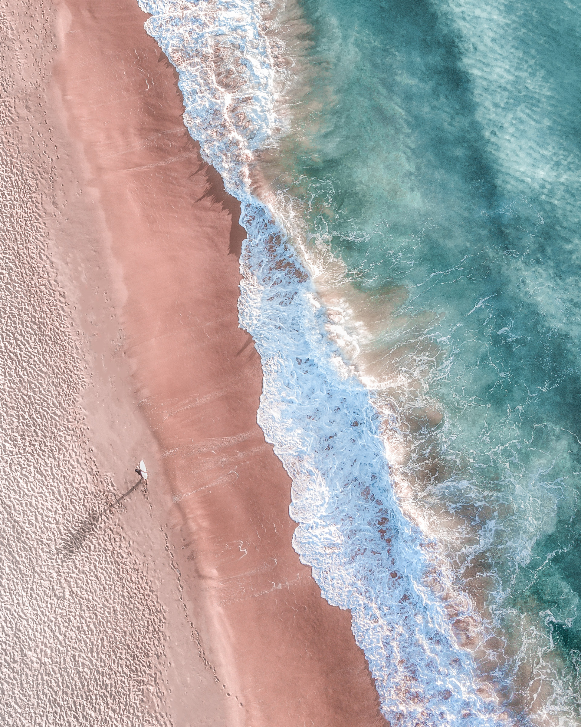 A completed morning surf session. From above, the shadows and textures of the ocean show off how unique our oceans are can be.